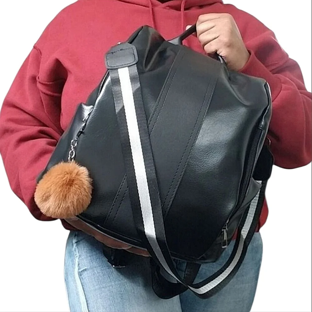 Black 2 way Convertible Vegan Leather pom pom backpack.